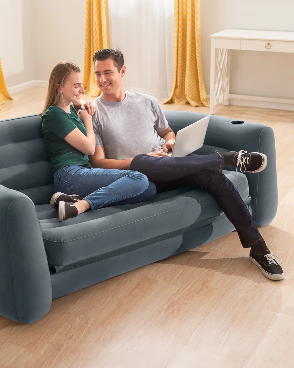 Two people relaxing on the inflatable sofa