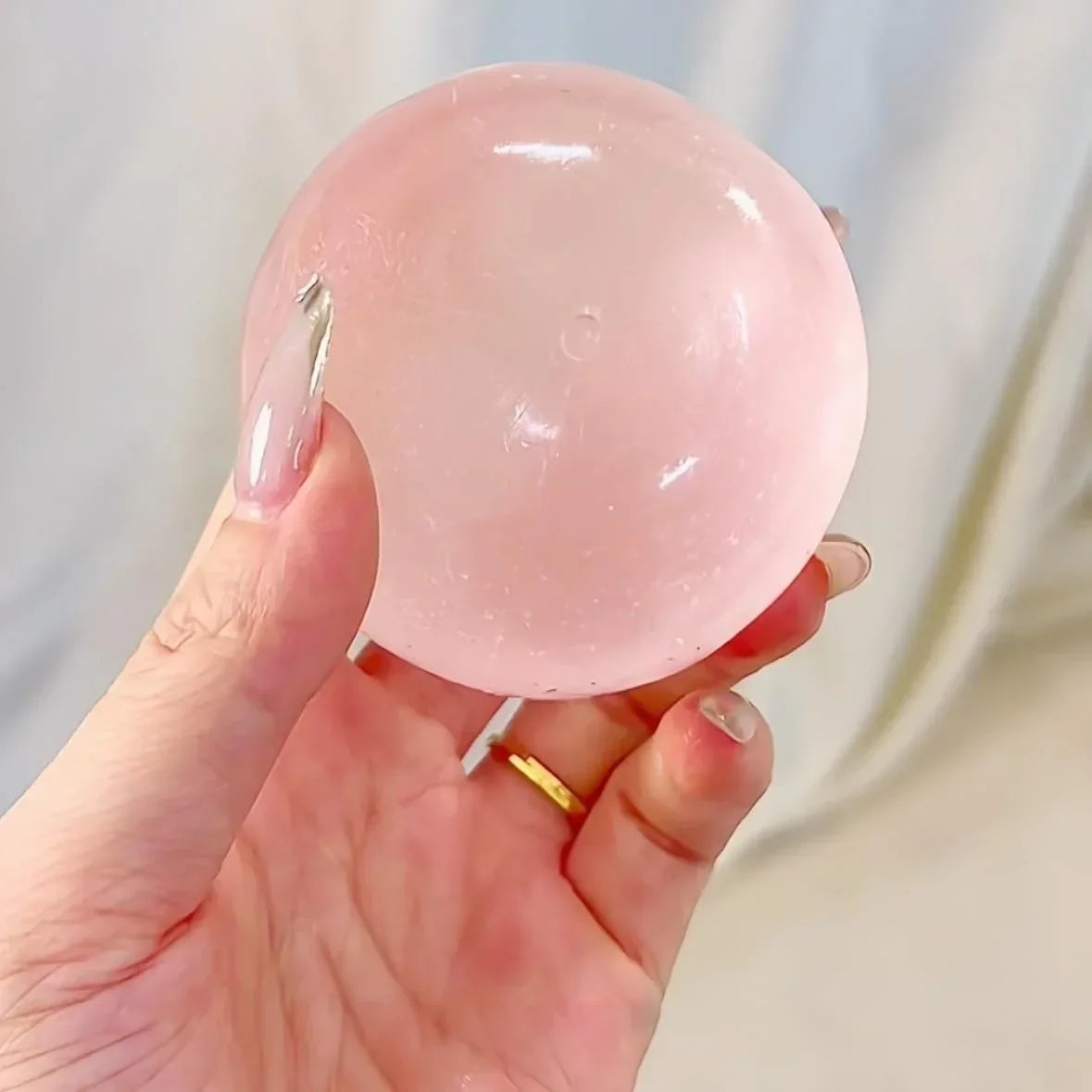 Pink stress ball held in the hand